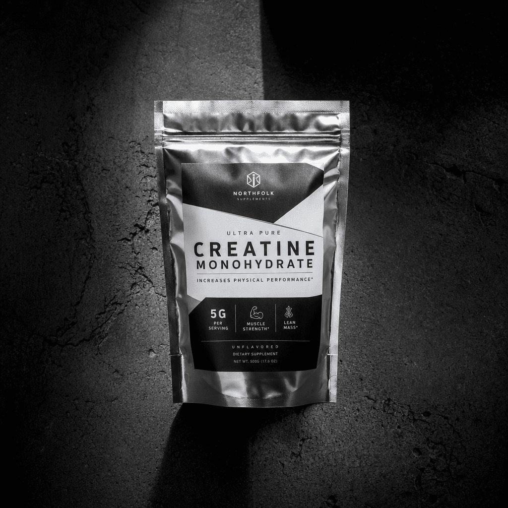 Silver metallic foil supplement pouch standing upright on dark textured concrete, dramatic top-down split light creating
