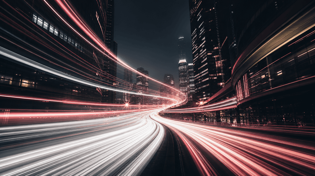 Abstract time-lapse style long-exposure cityscape at night with sweeping light trails of white and warm pink streaking t