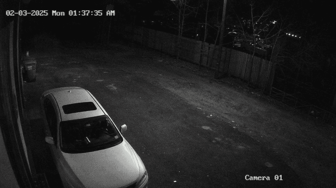 CCTV surveillance footage with glowing timestamp overlay, grainy authentic texture, minimal security lighting, fixed cam