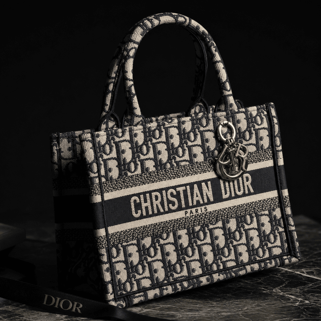 Designer handbag with soft directional lighting, dark background, luxury brand photography, fabric material texture visi