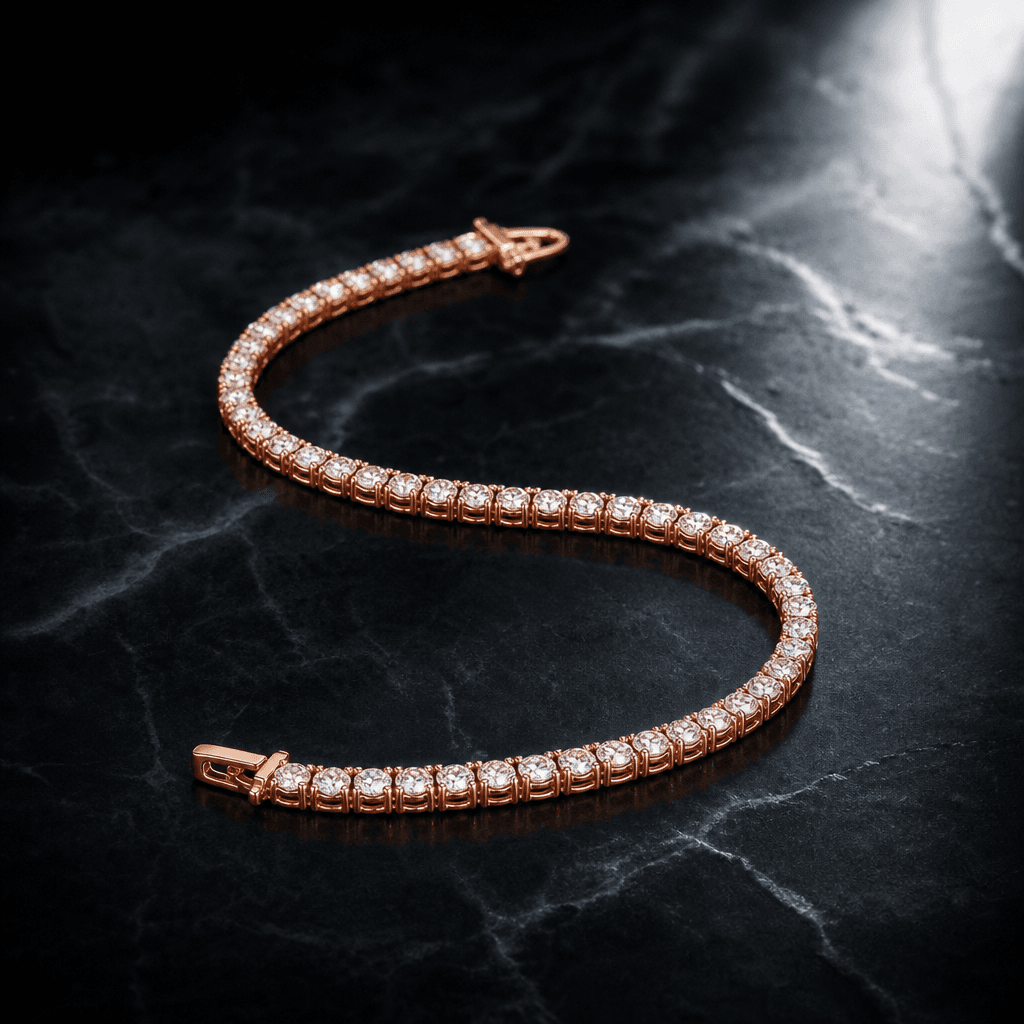 A rose gold tennis bracelet arranged in a gentle S-curve on cold dark marble, lit with a directional spotlight from the 