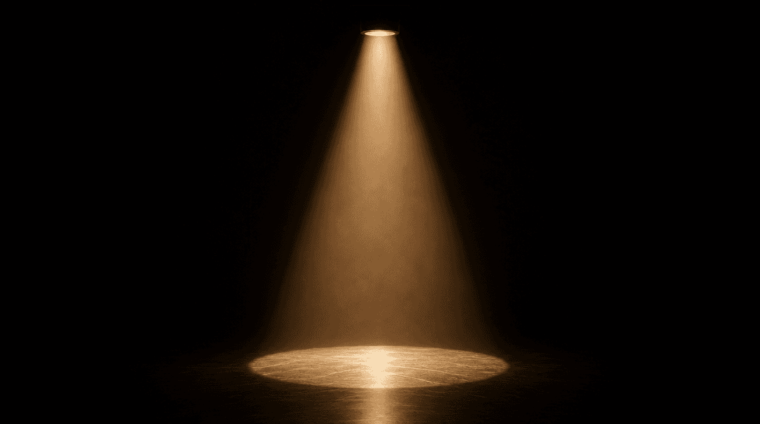 Abstract cinematic still life: a single tight cone of warm studio spotlight cutting through deep darkness and illuminati