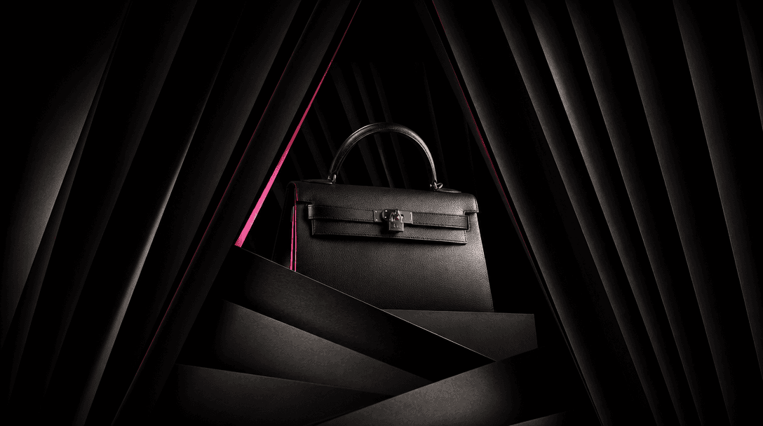 A luxury product emerging from layered black curtains and sculptural paper planes, symbolizing curated creative directio