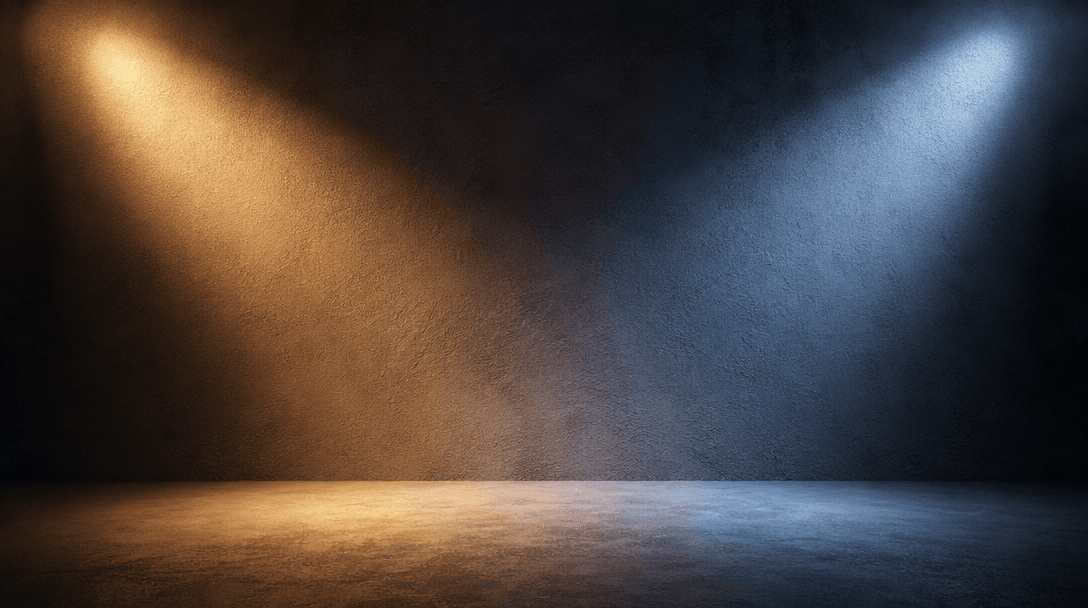Abstract studio lighting setup showing warm and cool light rays illuminating textured matte surface, professional photog