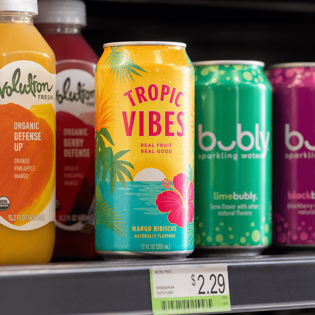 A colorful beverage can on a convenience store shelf surrounded by complementary products. Bright natural-looking retail