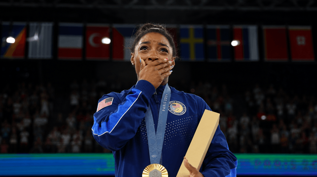 Dramatic Olympic moment—medal ceremony or climactic competition instant—professional ceremony lighting, emotional intens