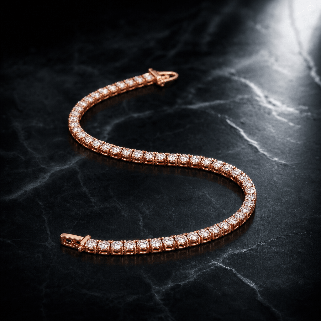 A rose gold tennis bracelet arranged in a gentle S-curve on cold dark marble, lit with a directional spotlight from the 