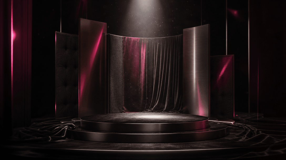 A dramatic miniature performance stage made from black velvet, brushed metal, and soft fabric panels, illuminated by a s