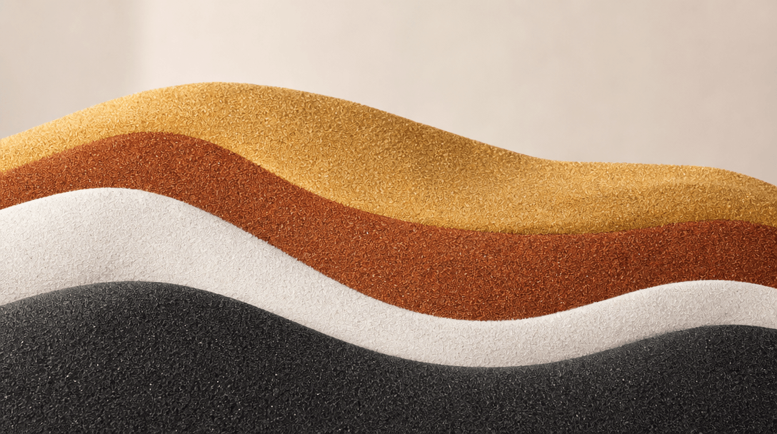 Artistic scene showing multiple sand colors stacked in elegant layers—gold, copper, white, charcoal—in smooth flowing tr