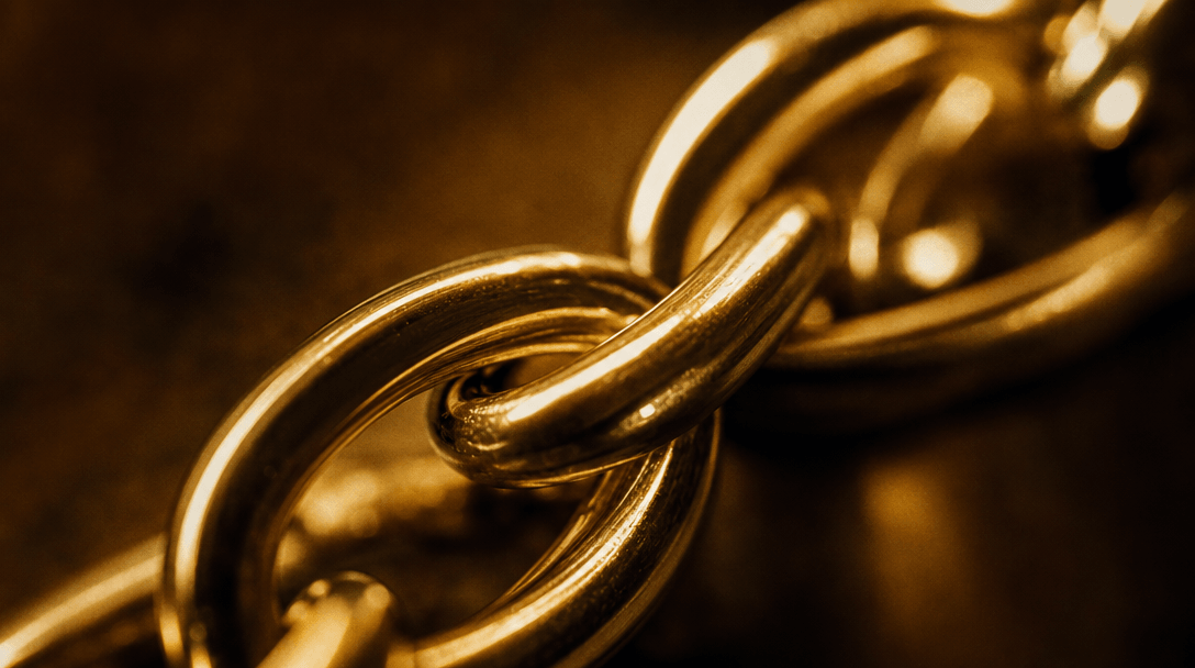 Abstract macro: polished gold chain links in sharp focus against a warm dark editorial background, cinematic film grain,