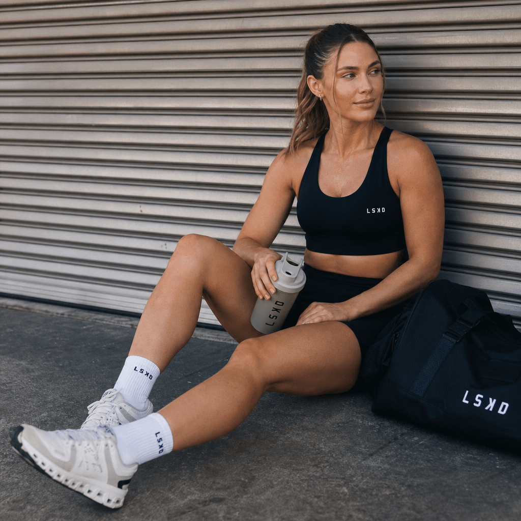 Lifestyle sports moment. Athlete relaxing after workout wearing product, casual urban athletic setting, natural soft lig