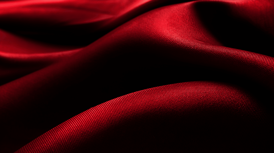 Extreme macro landscape of crimson silk folds, precise highlights revealing weave, tension and soft sheen, deep black va