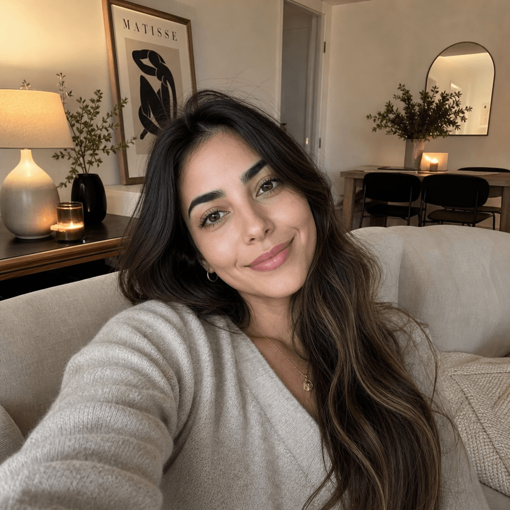An elegant indoor lifestyle photo of a person relaxing in a stylish living room, transformed from a selfie. The lighting