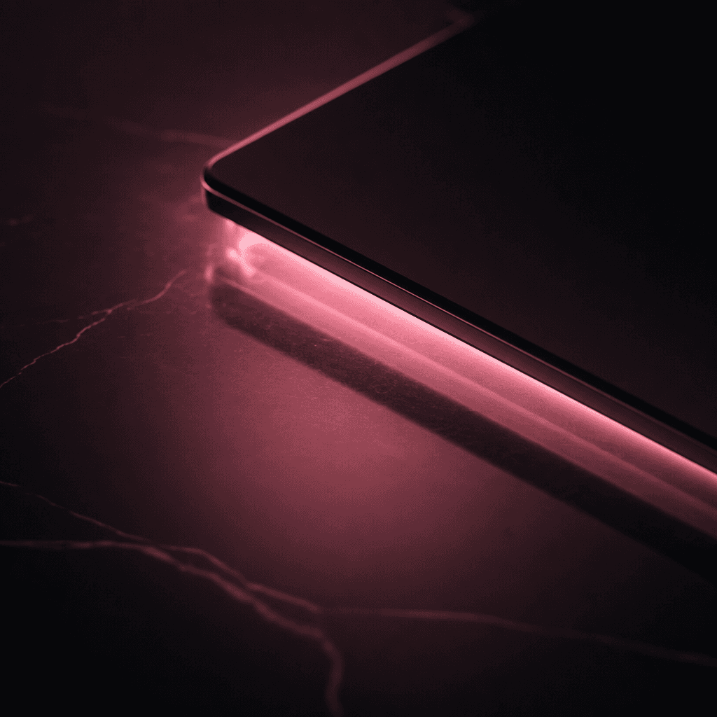 Dark editorial flat lay: a glowing device casting soft pink light onto a polished near-black reflective surface. Abstrac