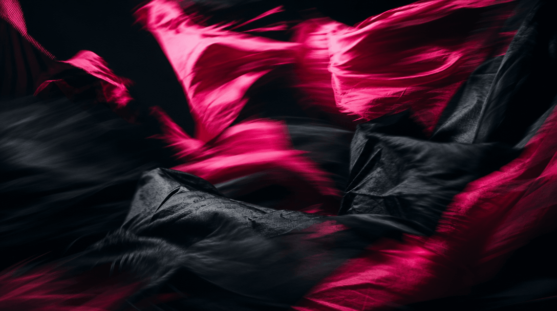 Abstract cinematic motion: deep black and hot pink fabric fragments blurring in dynamic movement against a near-black ba