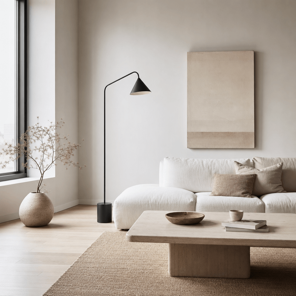 Scandinavian minimalist living room — soft diffused natural window light, pale oak flooring, low white sofa with linen c
