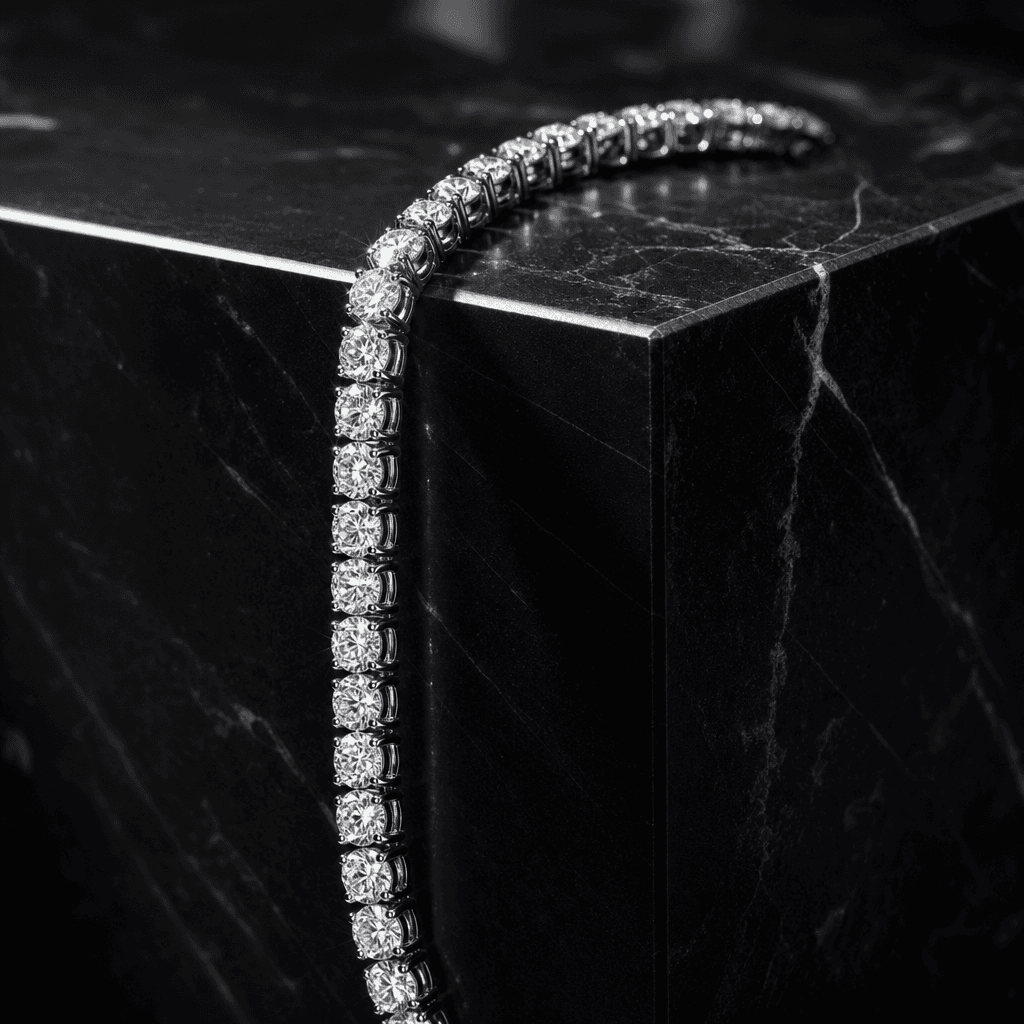 A platinum diamond tennis bracelet draped over the sharp edge of a black marble cube. High-contrast directional studio l