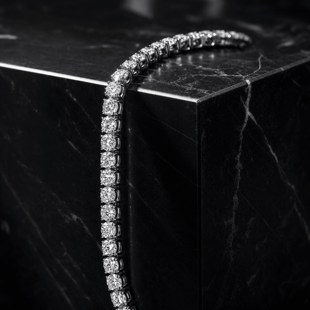 A platinum diamond tennis bracelet draped over the sharp edge of a black marble cube. High-contrast directional studio l