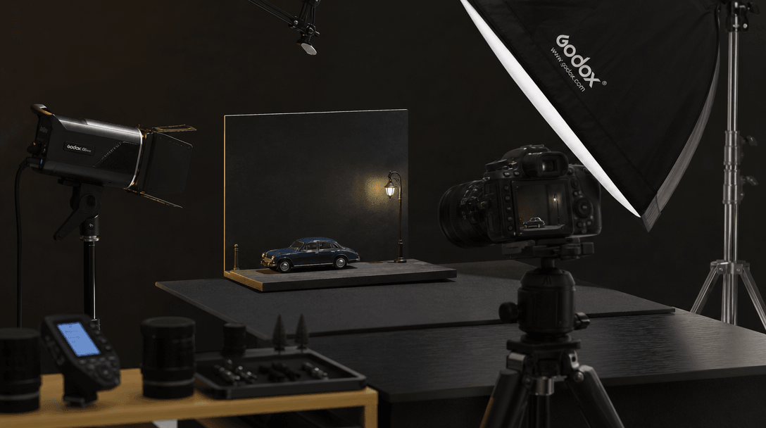 Professional product photography setup with miniaturized objects and studio lighting equipment, dark editorial style com