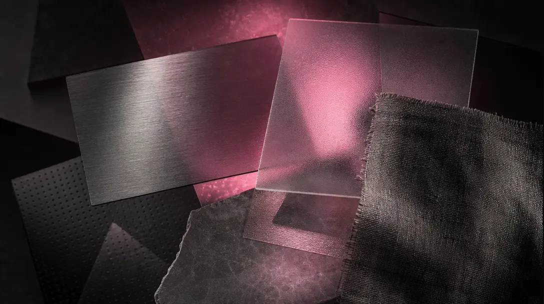 Multiple overlapping translucent material swatches — brushed metal, frosted glass, textured fabric — layered in a dark e