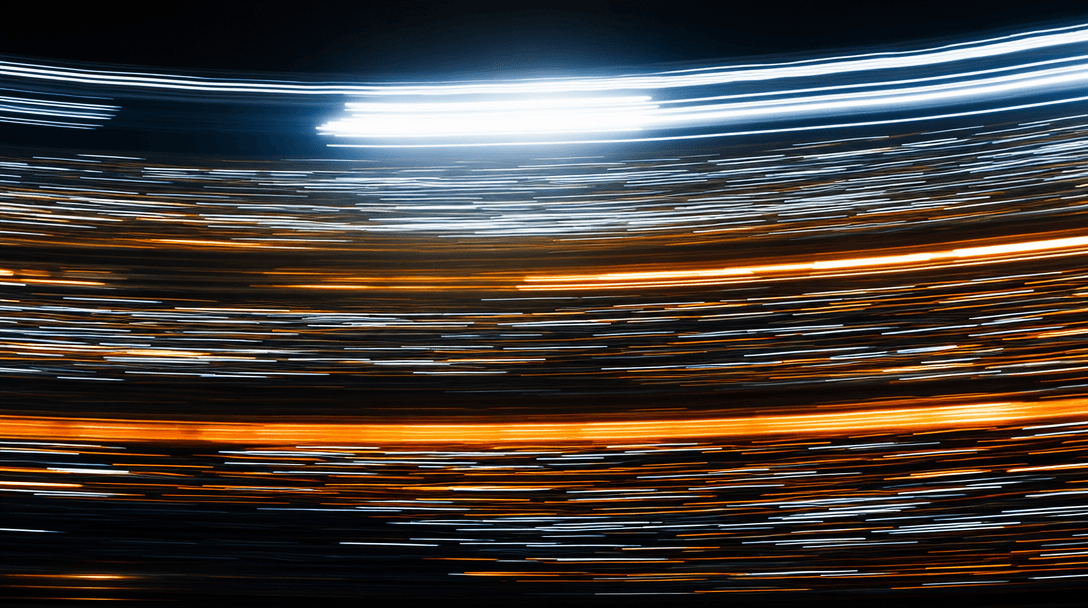Long exposure abstraction of stadium crowd motion: streaks of warm amber and cool white light from floodlights and phone