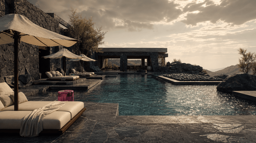 An architectural pool surrounded by dark stone, cream linen, sculptural umbrellas, and sparkling water, cinematic wide f
