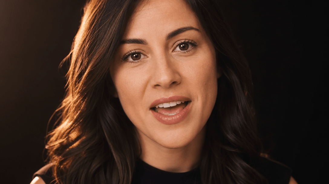 Close-up of a person speaking with natural lip movement and genuine expression. Soft warm key light from the left, profe