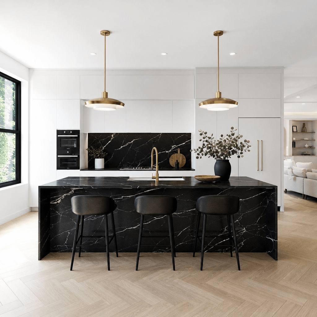 Modern open-plan kitchen — crisp white flat-front cabinetry, black marble waterfall island, architectural brass pendant