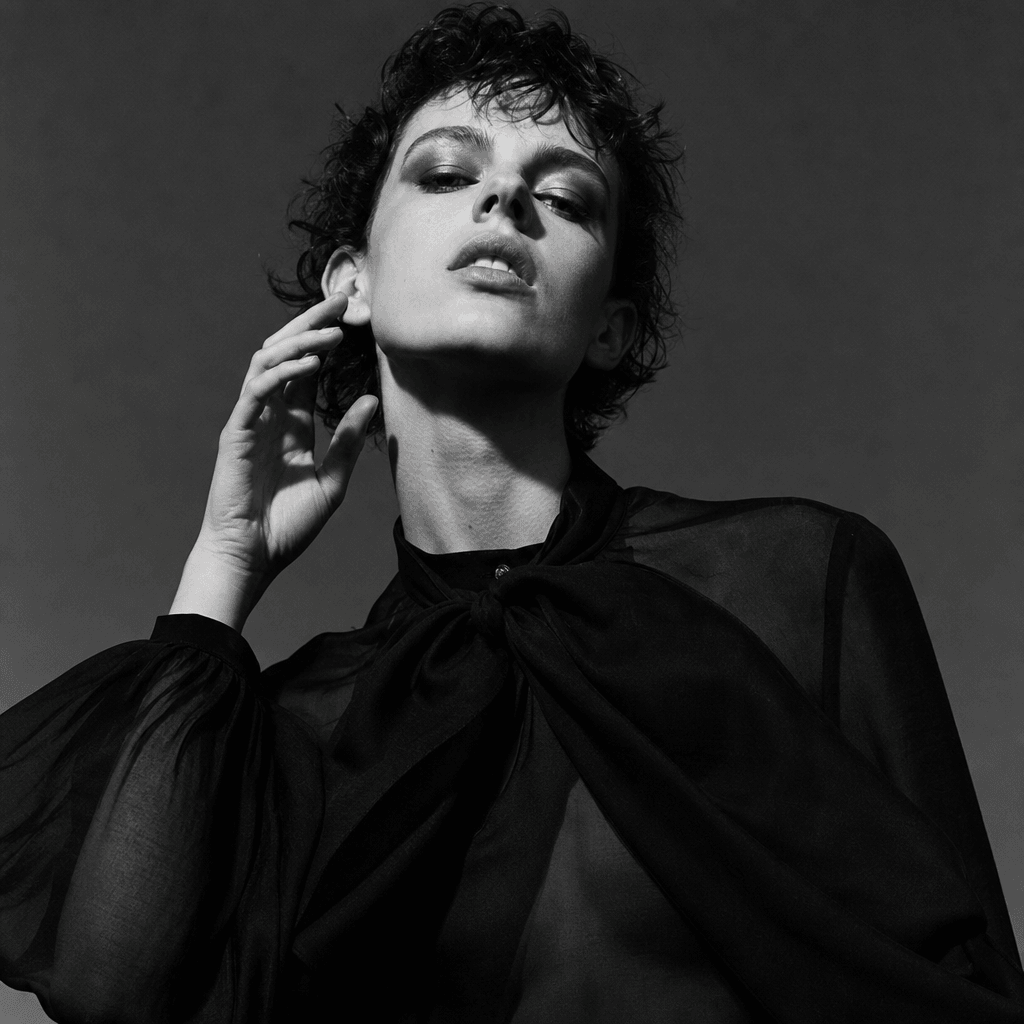Fashion editorial monochrome portrait, high contrast, dramatic lighting, magazine quality, black-and-white fashion photo