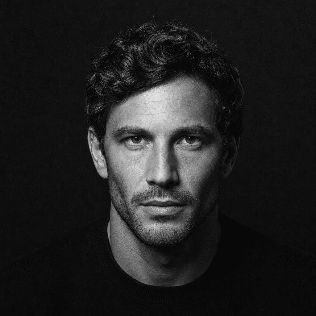 Square monochrome studio portrait of an anonymous adult man wearing a simple black crewneck, dramatic overhead softbox c