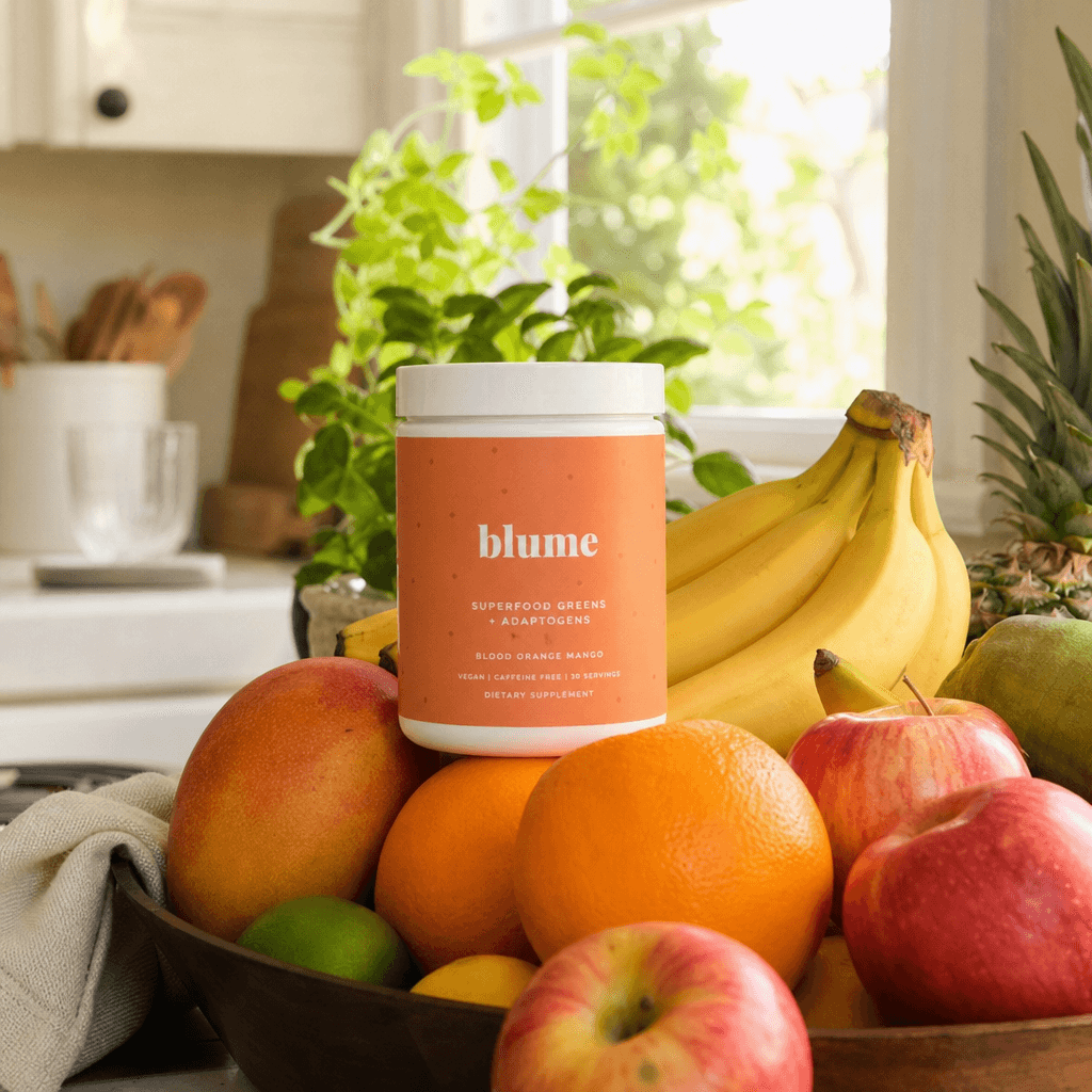 Product lifestyle moment. Beverage or health product nestled naturally in fruit pile on kitchen counter, warm natural da