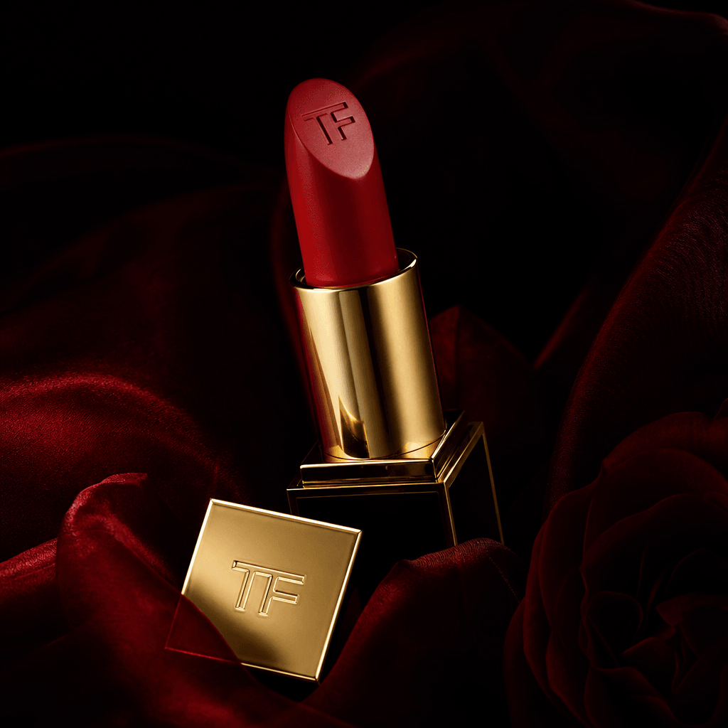 Luxury lipstick product positioned sensually, editorial photography, sophisticated styling, dark luxurious background, d
