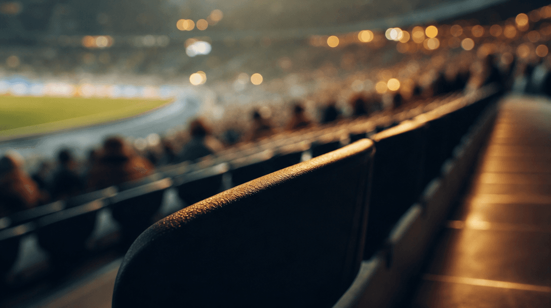 Perspective study of stadium tribune rows seen from a seated viewpoint, extreme shallow depth of field on nearest seat e