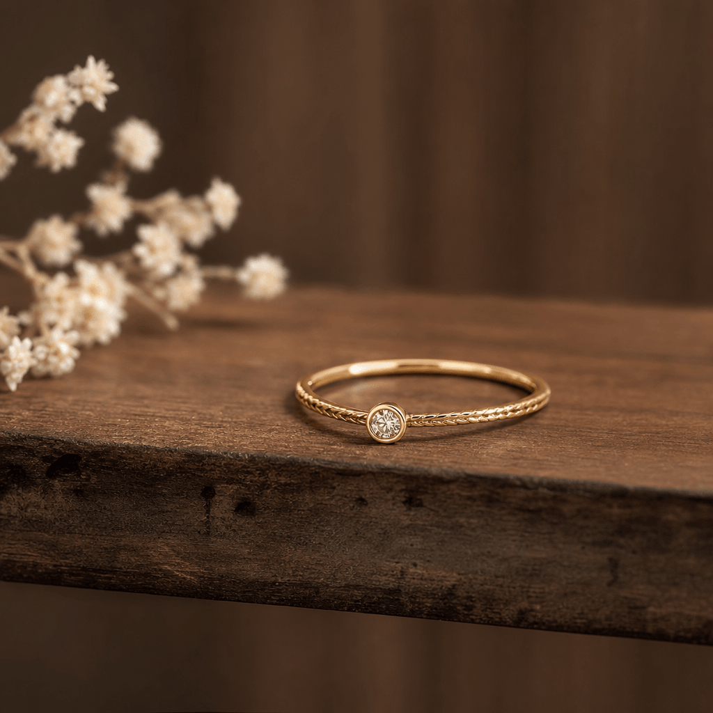 Gold ring or delicate necklace displayed on rustic wood shelf, shallow depth of field, warm studio lighting, elegant jew