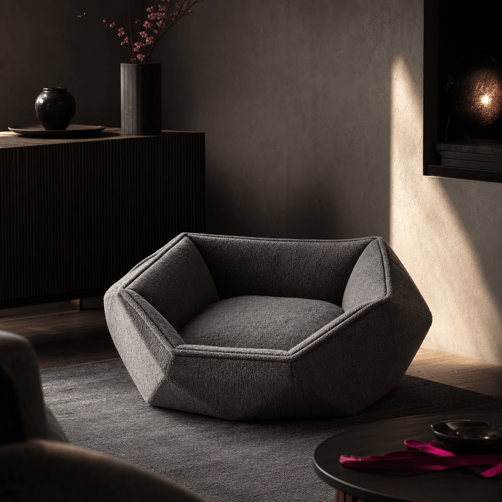 A plush geometric pet bed staged in a refined contemporary interior with dark wood, textured plaster, and a narrow beam