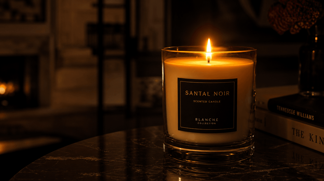 Dark interior scene with a single luxury candle lit and glowing warmly against deep shadows. Realistic flame flicker, wa