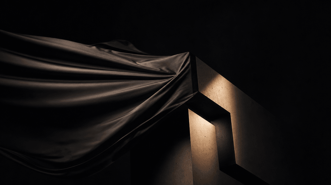 Abstract motion study — dark silk fabric unfurling in slow motion against a near-black background, gradually revealing a