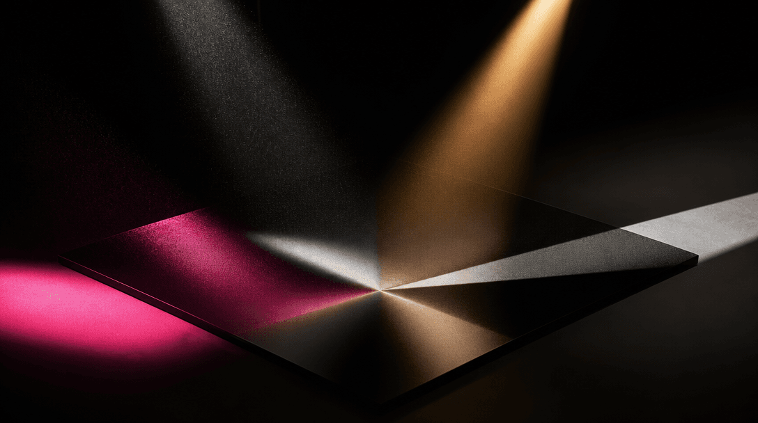 Four distinct beams of studio light converge onto a single polished black photographic surface, each beam carrying a dif