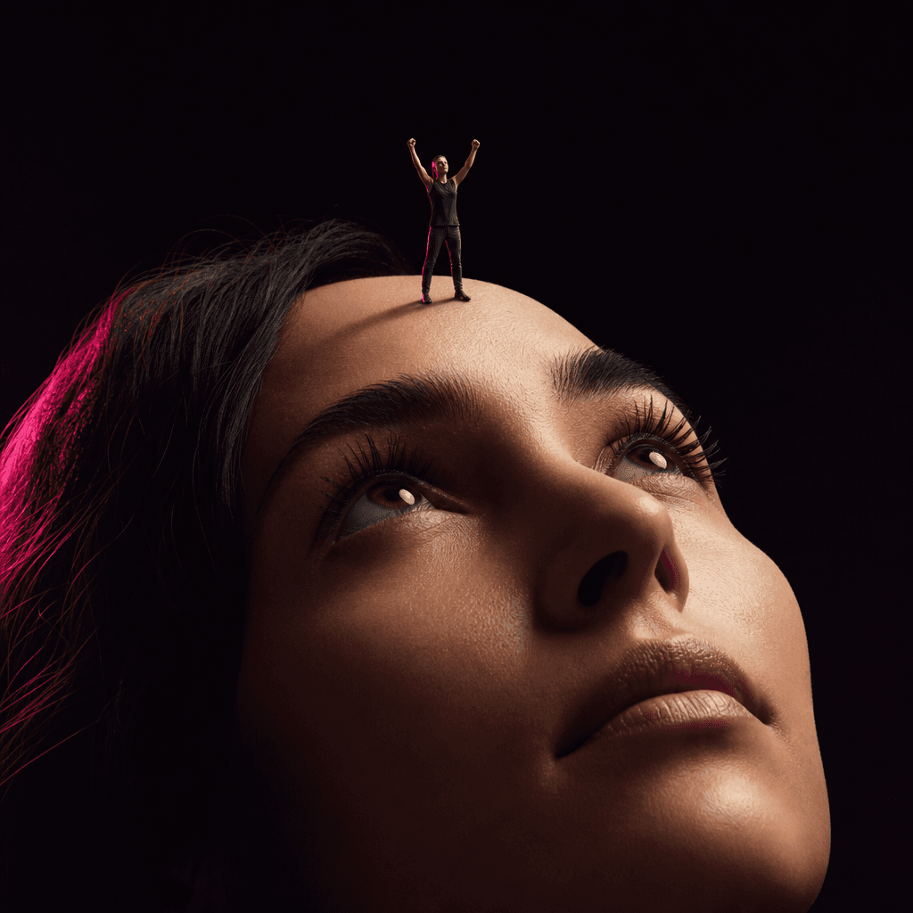 Tiny figure in triumphant pose with raised arms standing on forehead, dramatic side-lit cinema lighting, deep black back