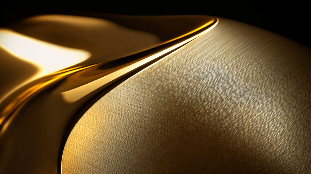Abstract close-up of polished yellow gold surface transitioning into brushed finish. Warm amber specular highlights on m