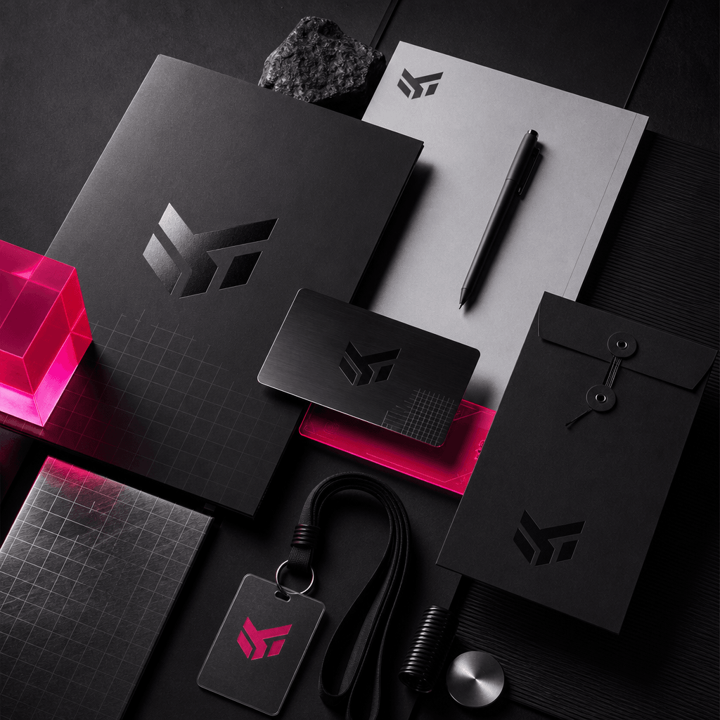 A bold technology brand identity collection with black metal cards, electric pink accent materials, geometric logo forms