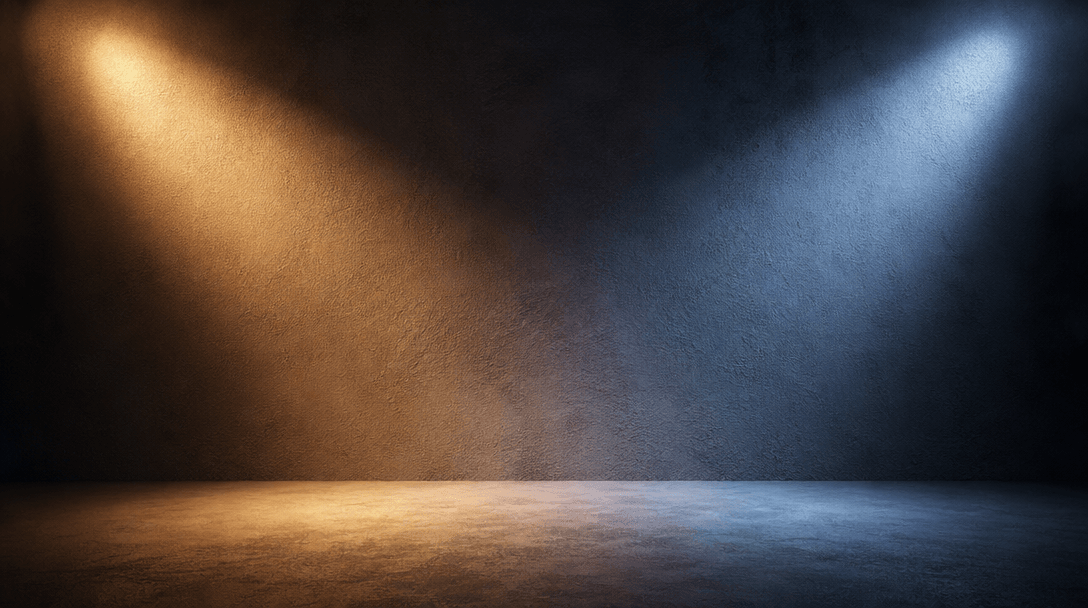 Abstract studio lighting setup showing warm and cool light rays illuminating textured matte surface, professional photog