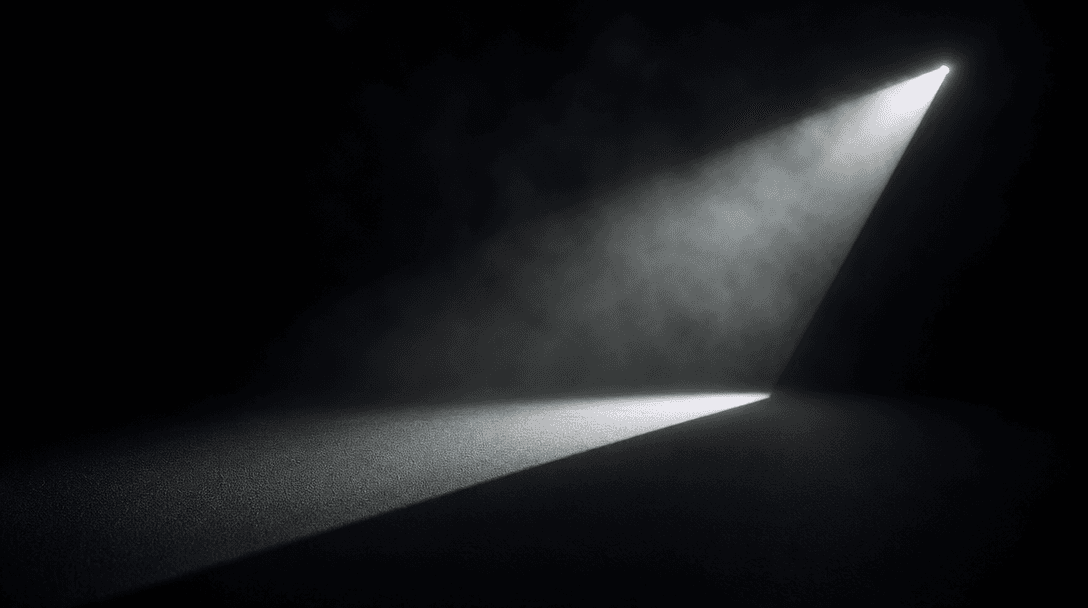 Abstract studio lighting composition: a single hard light source on a seamless dark surface near #0A0A0F casting a sharp