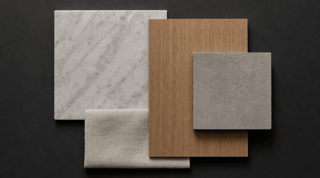 A flat lay of interior material and finish samples — honed marble slab, warm brushed oak veneer, raw concrete tile, natu